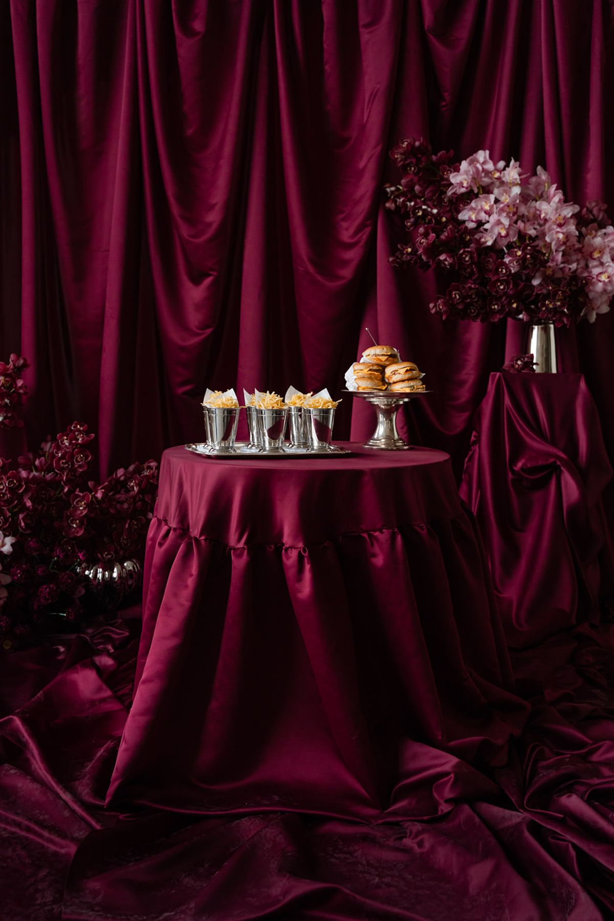 Late-night burger station with satin backdrop and orchids at Domaine des Halles
