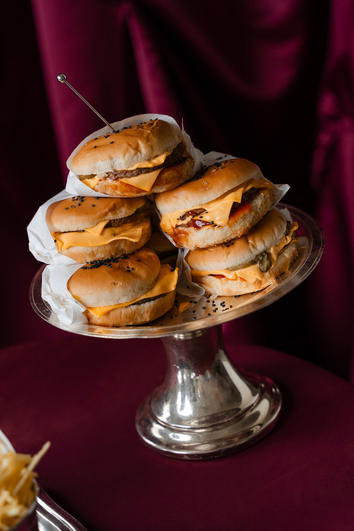 Cheeseburgers on silver pedestal stand at Domaine des Halles wedding after-party