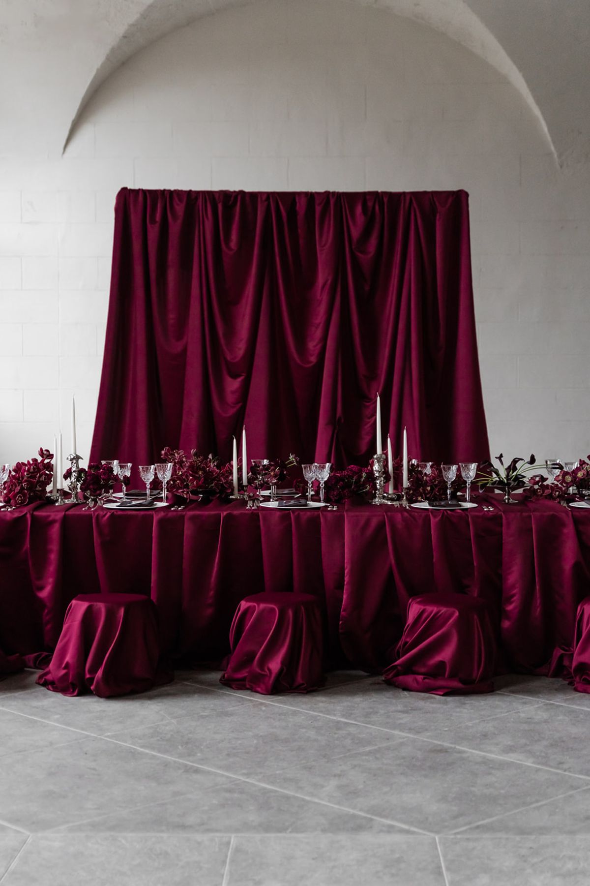 Red table linen against a satin backdrop at Domaine des Halles