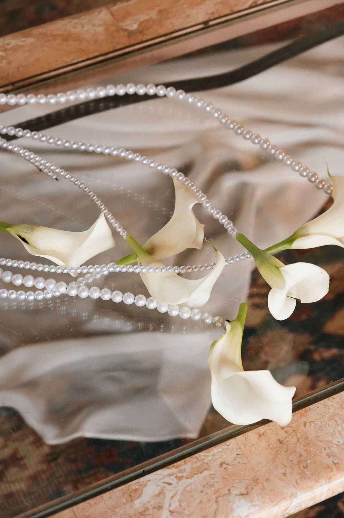 Pearls and calla lilies on bridal veil at Chateau d'Hazeville