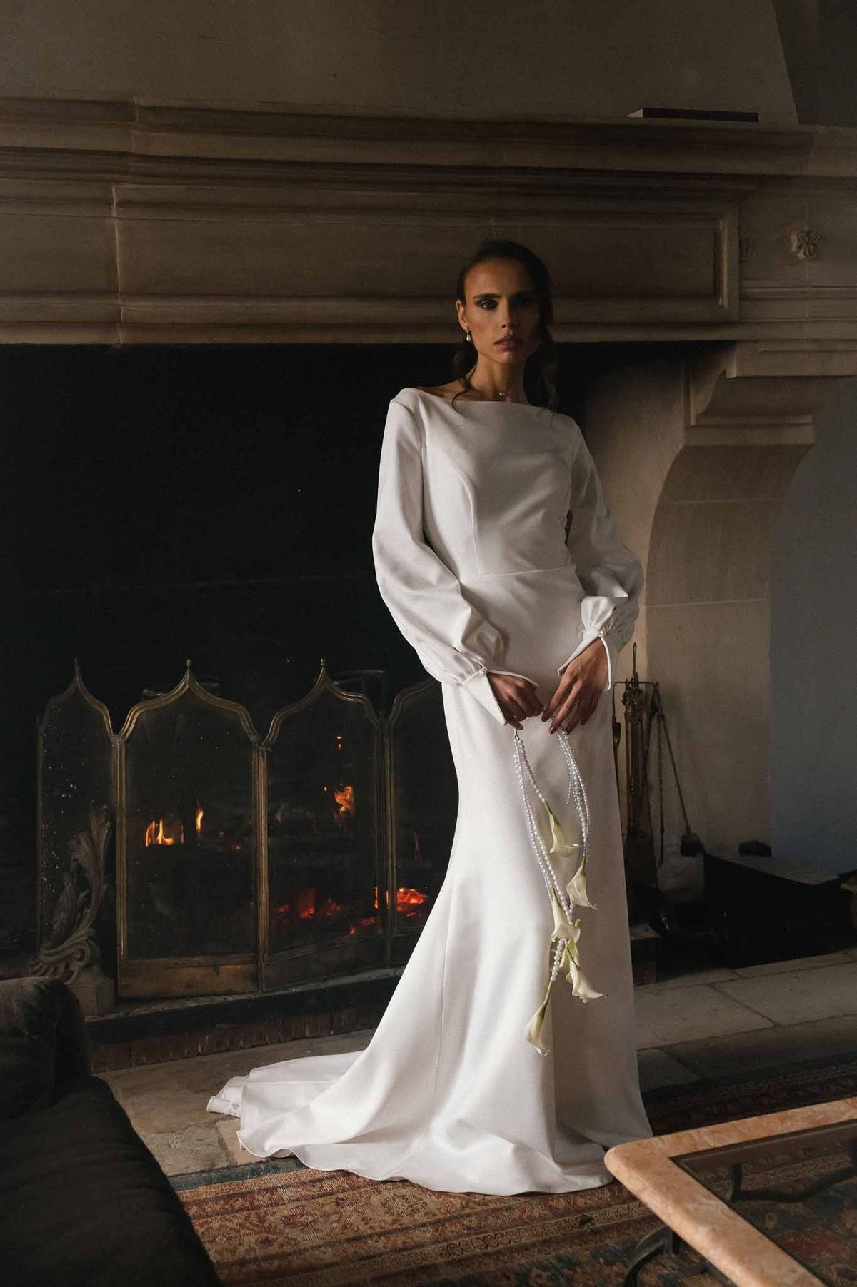 Bride by fireplace at Chateau d'Hazeville