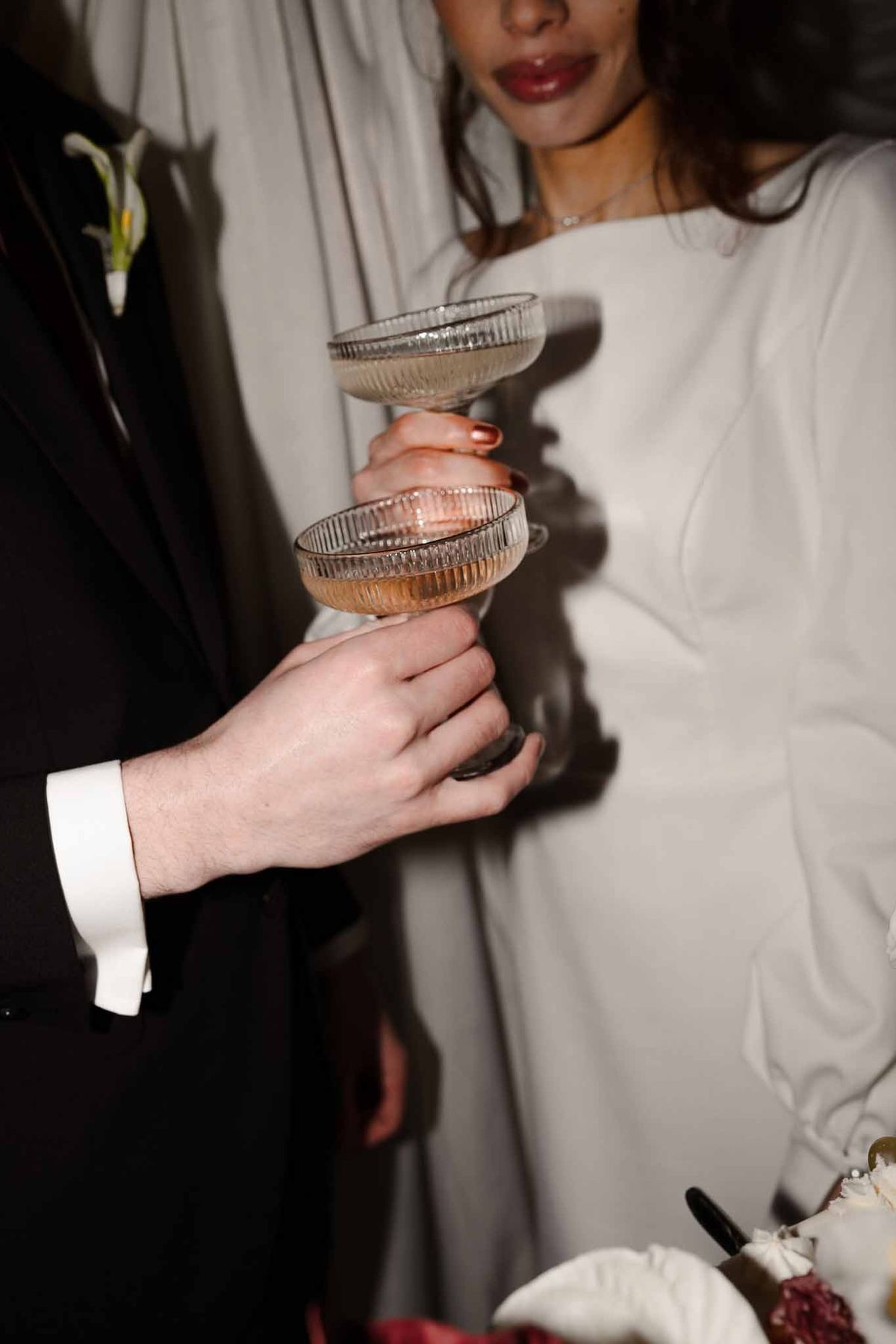 Couple toasting with champagne coupes at Chateau d'Hazeville