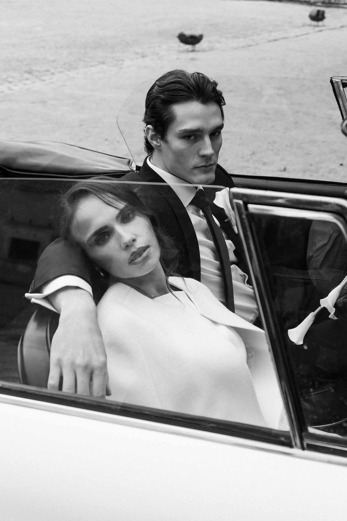 Couple in white vintage convertible at Chateau d'Hazeville