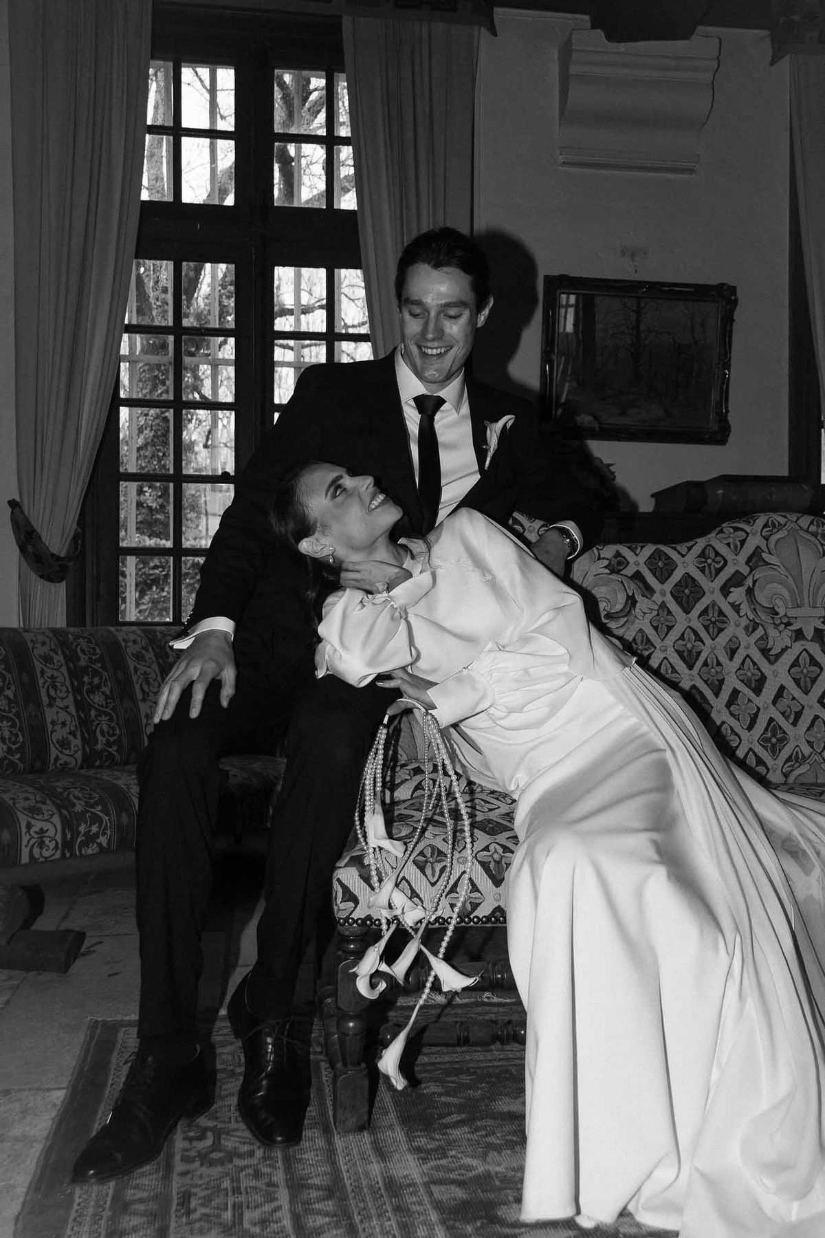 Couple laughing on sofa at Chateau d'Hazeville