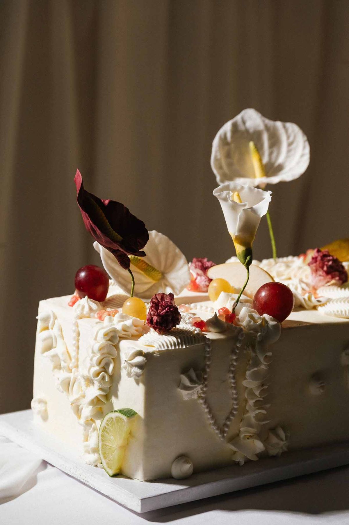 Artistic square wedding cake with anthuriums at Chateau d'Hazeville