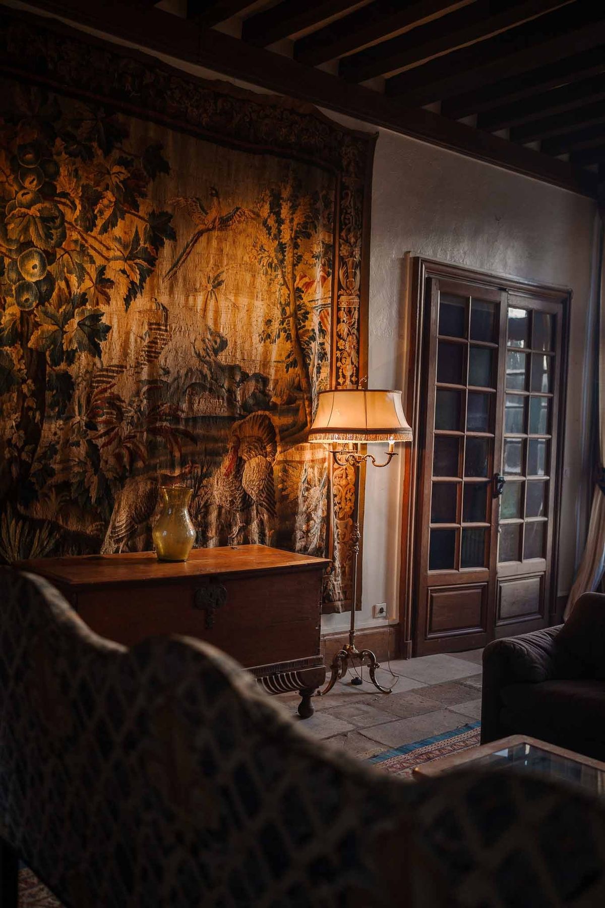 Tapestry and antique furnishings in salon at Chateau d'Hazeville
