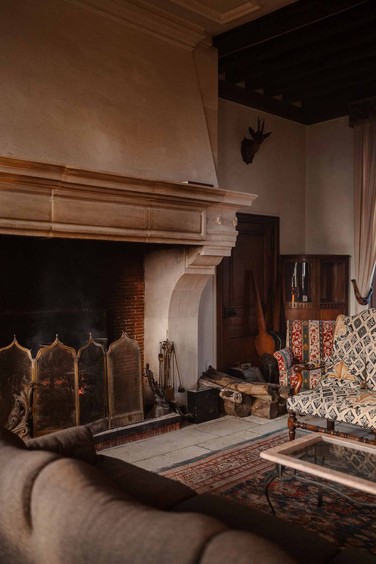 Stone fireplace in living room at Chateau d'Hazeville