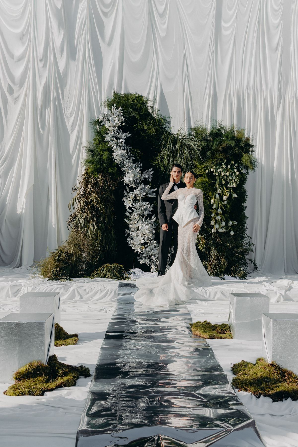 Bride and groom at the altar installation at the end of the mirrored aisle
