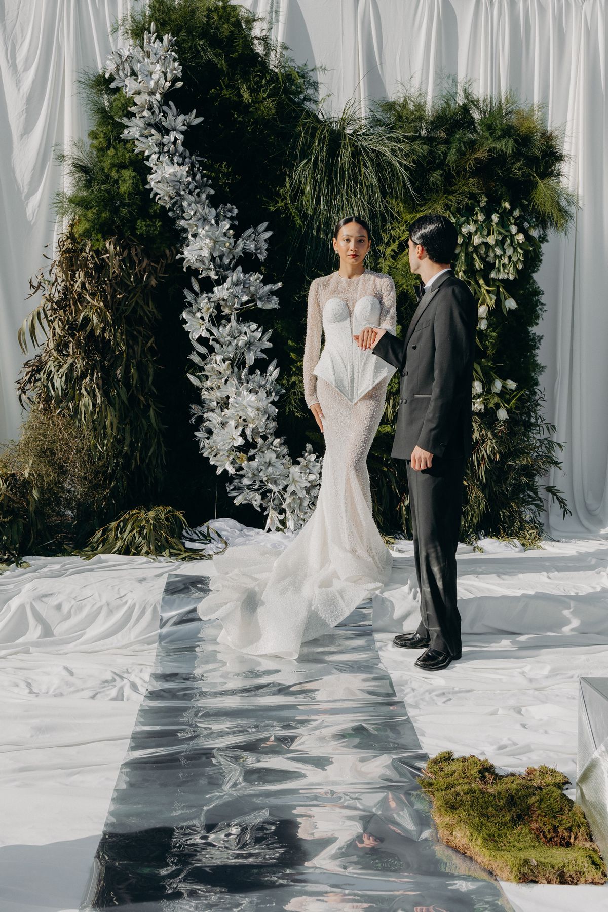 Bride and groom together at the floral altar