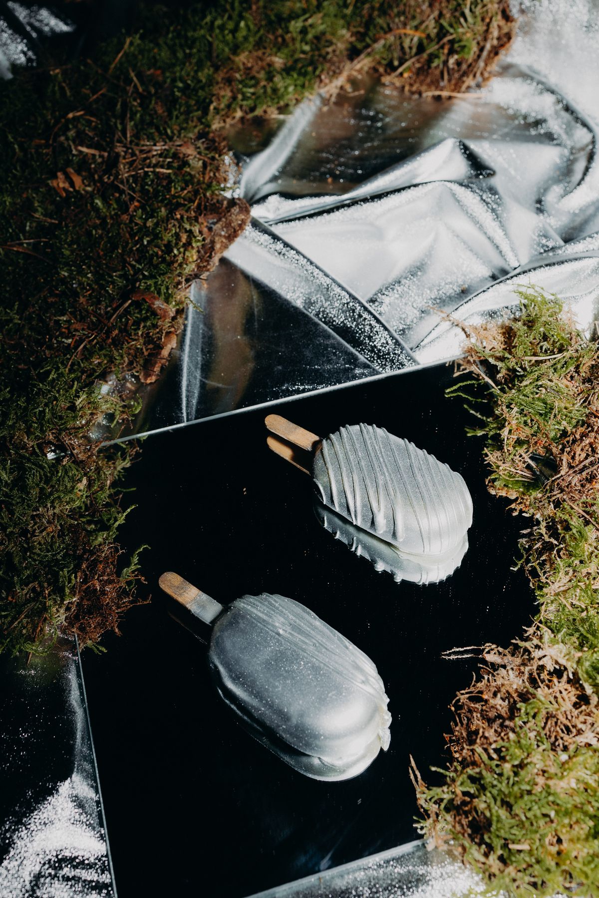 Trompe-l'oeil ice cream desserts set on moss