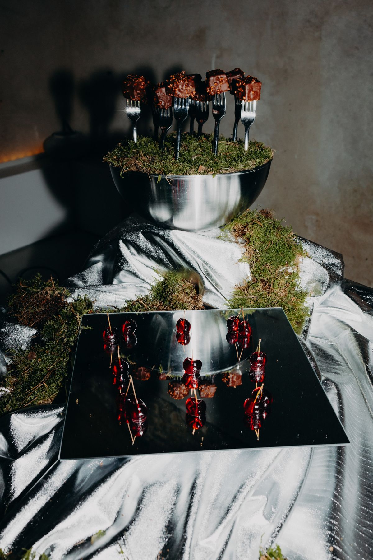 Red dessert bites served on a chrome stand