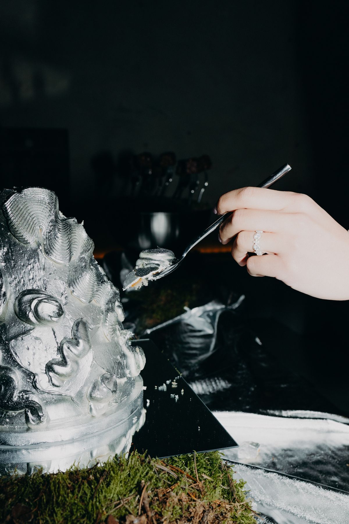 Finishing the sculptural silver wedding cake by hand