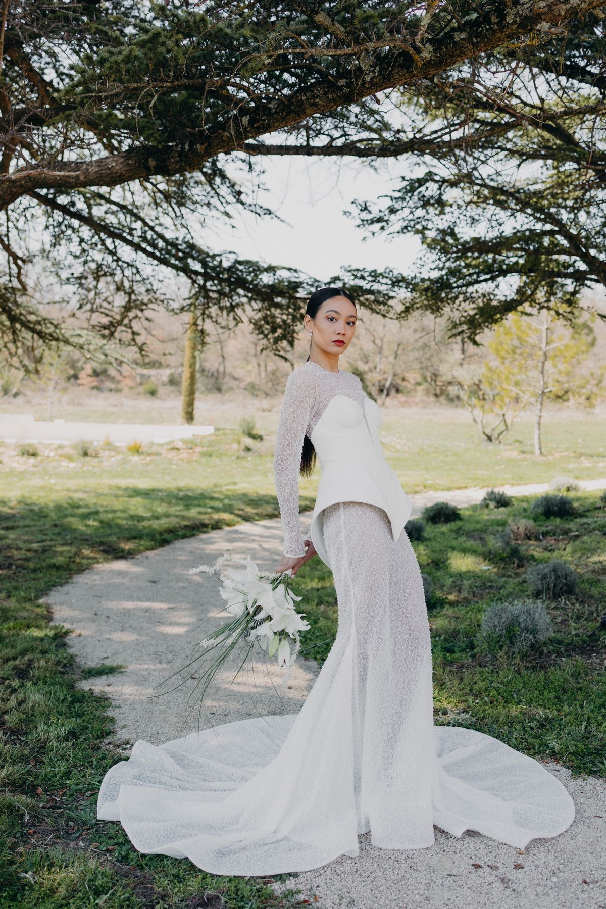 Bride in a beaded Manon Gontero gown on the garden path