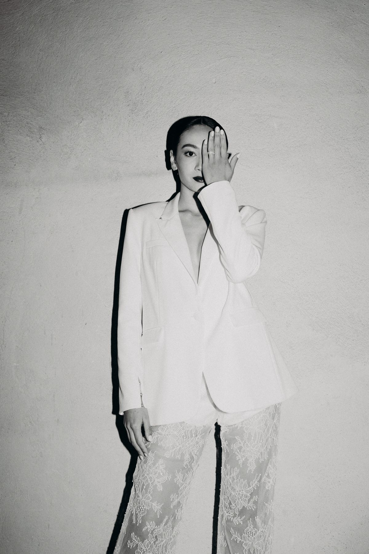 Bride in a white tailored suit, black and white portrait