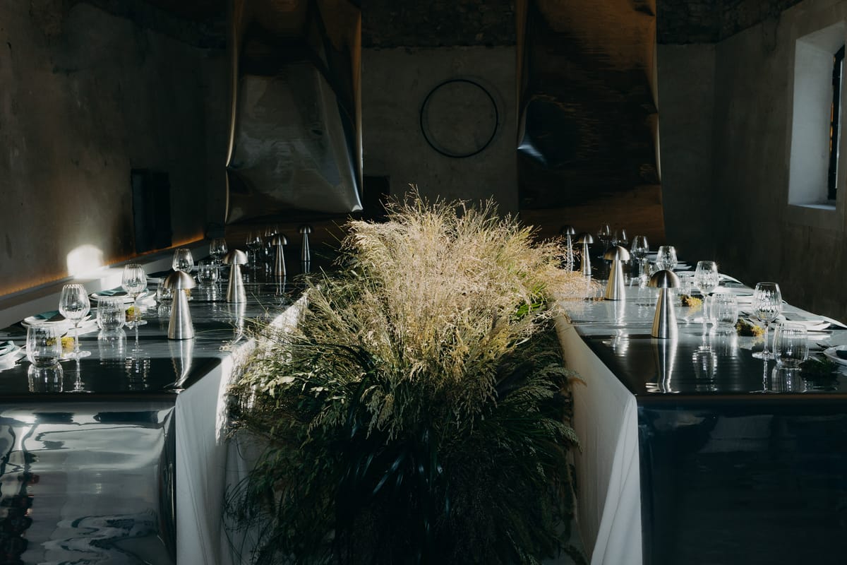 Reception tablescape with grasses and reflective centrepieces
