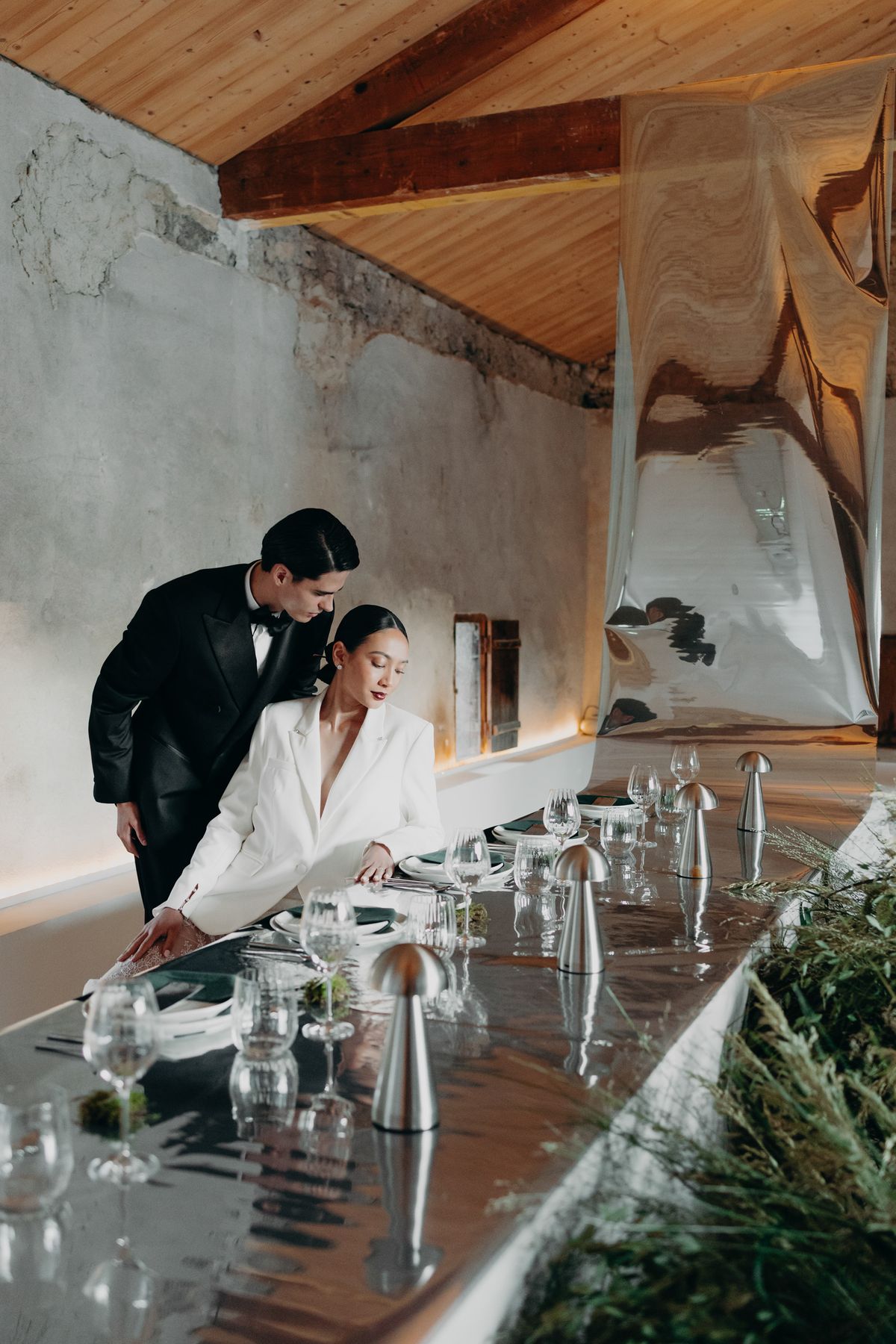 Bride and groom at the head of the reception table