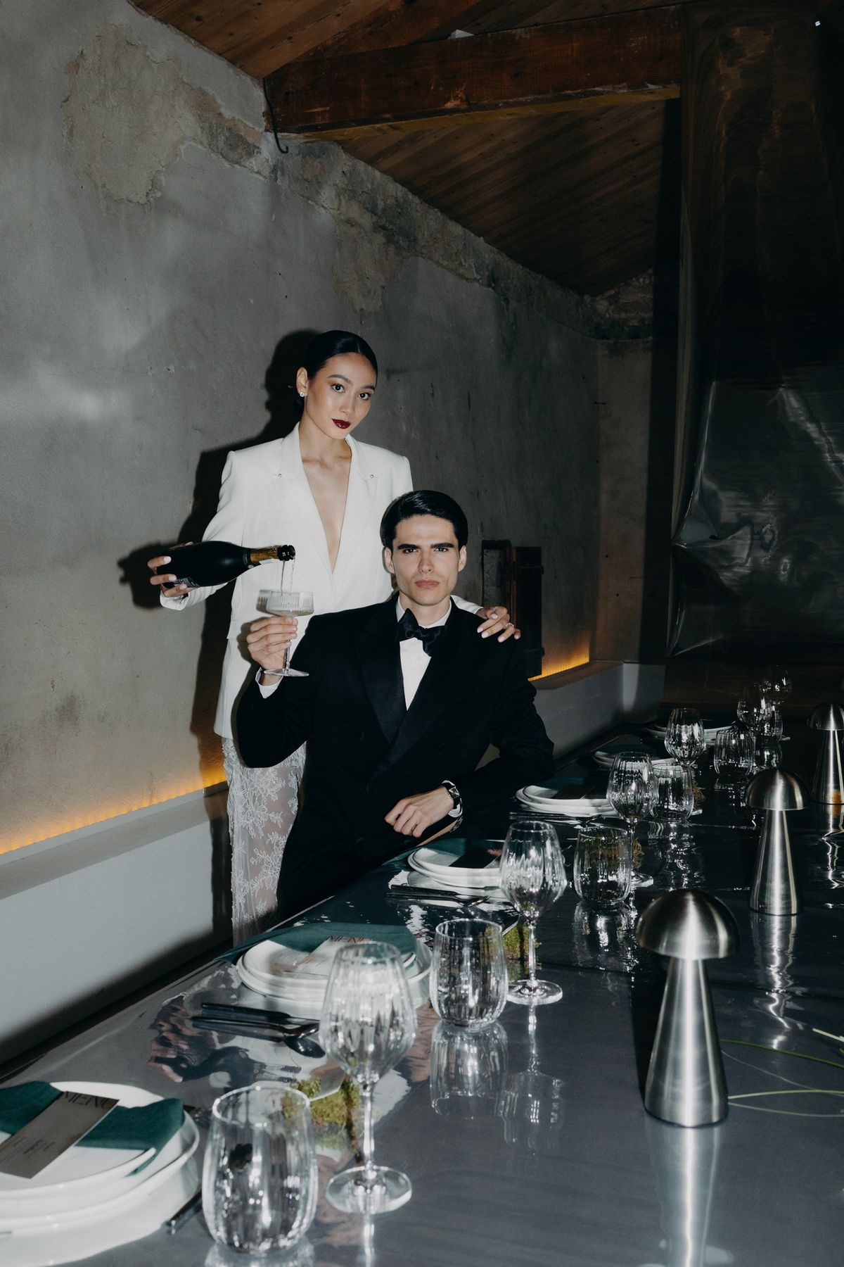 Bride and groom with drinks at the reception table