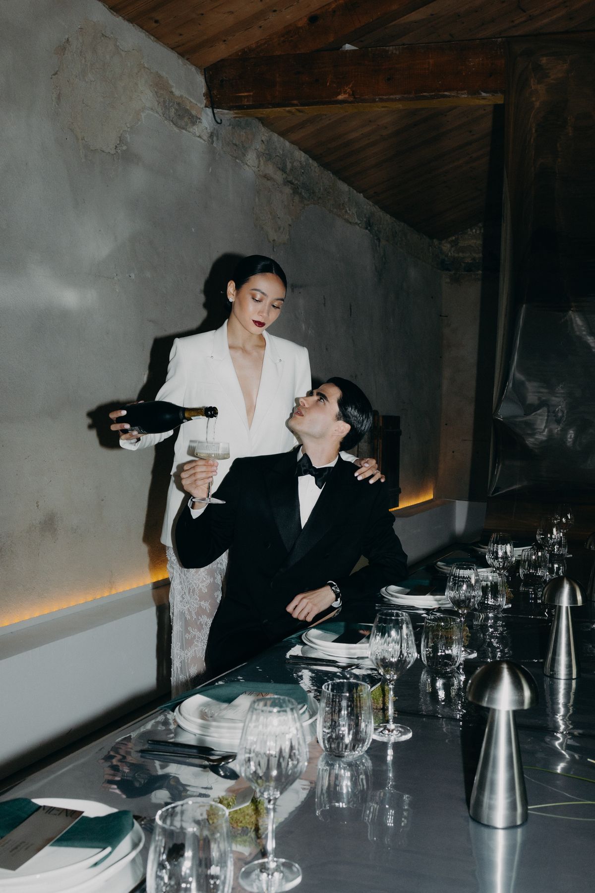 Bride and groom seated at the chrome dinner table