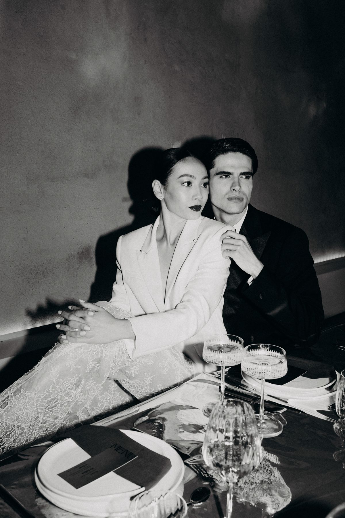 Bride and groom at the reception table, black and white