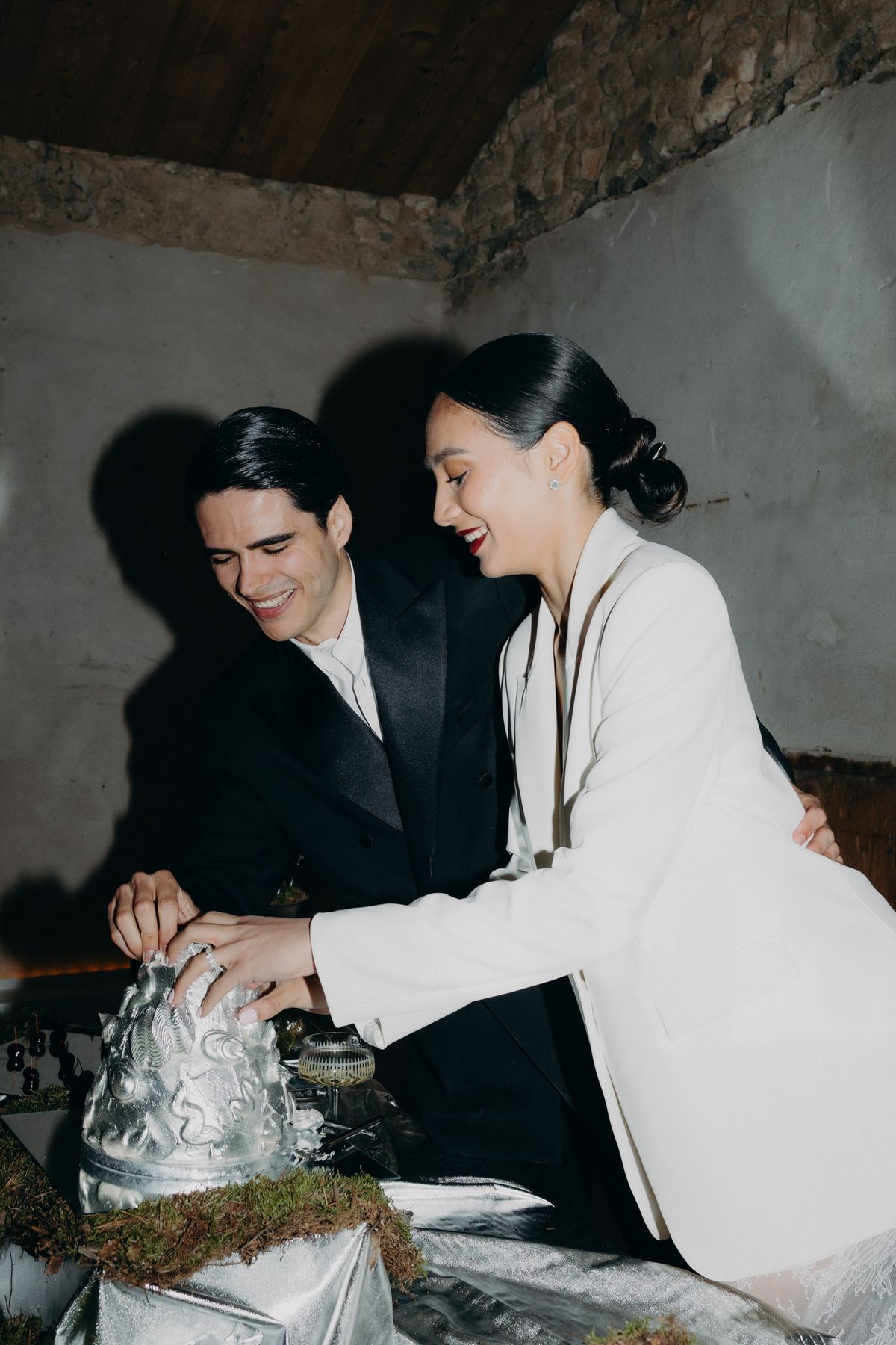 Bride and groom cutting the cake together