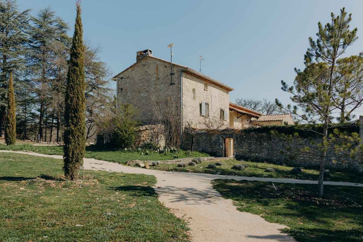 Cypress and pine framing the fortified Mas at Les Hauts de Sénanque