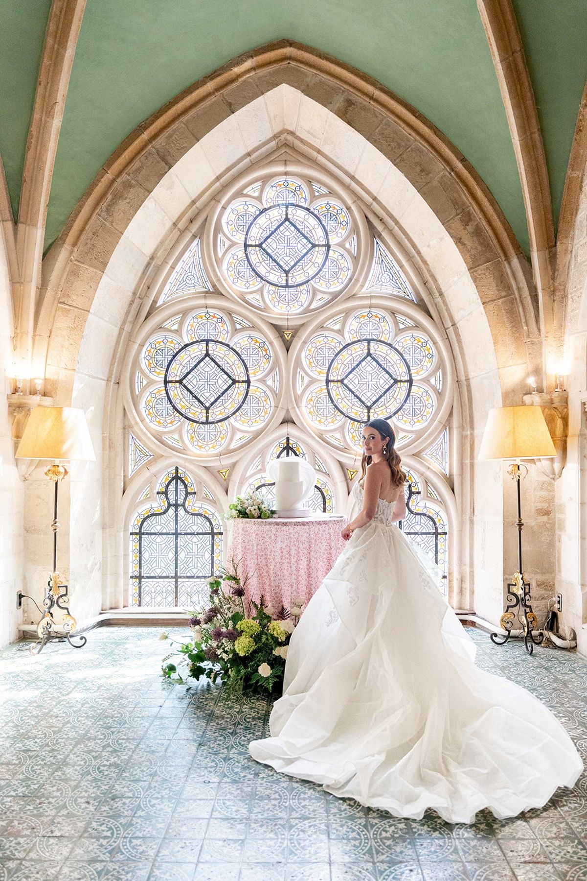 The bride in the abbey chapel, her train spread across the tiled floor