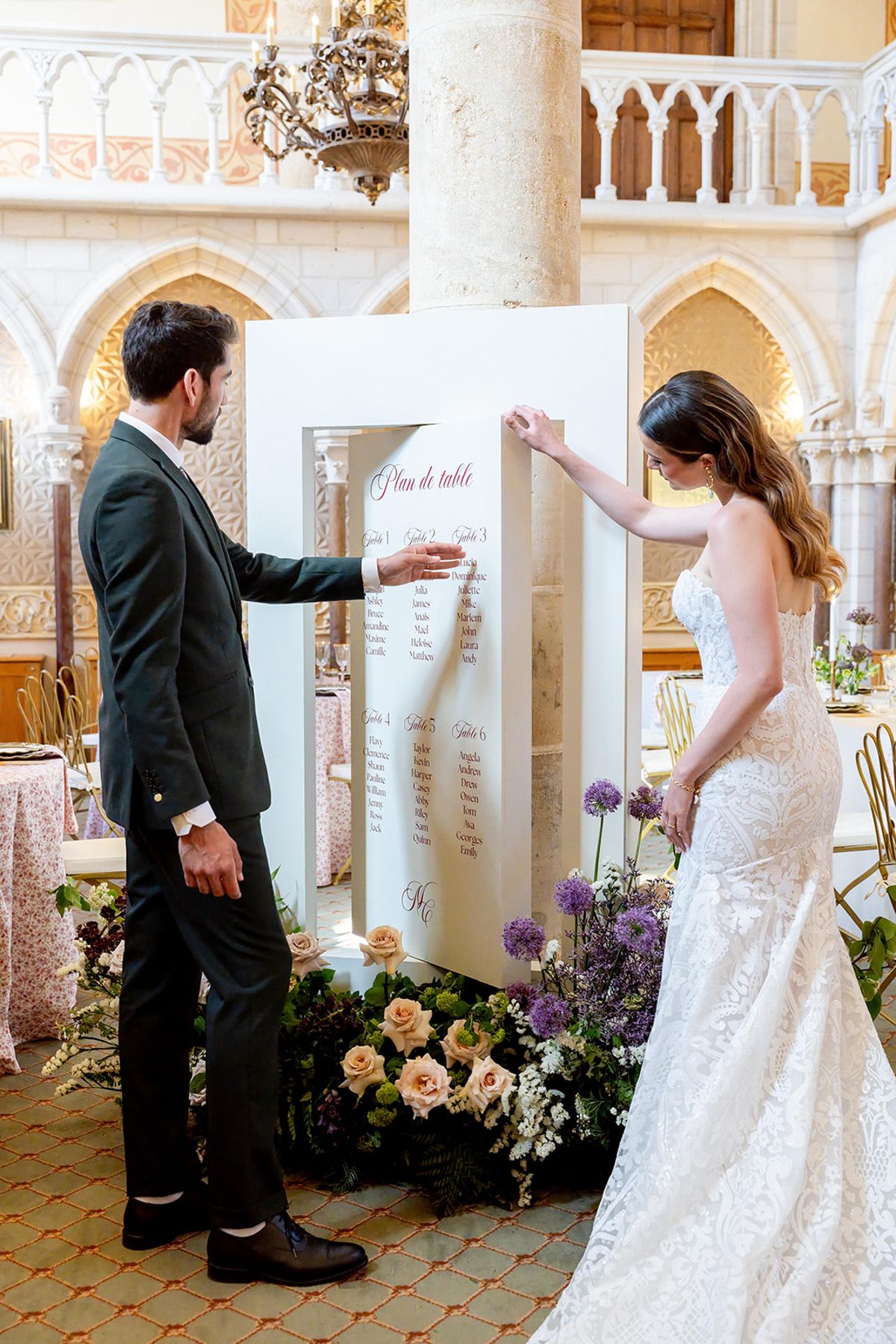 The couple at the seating plan in the reception hall