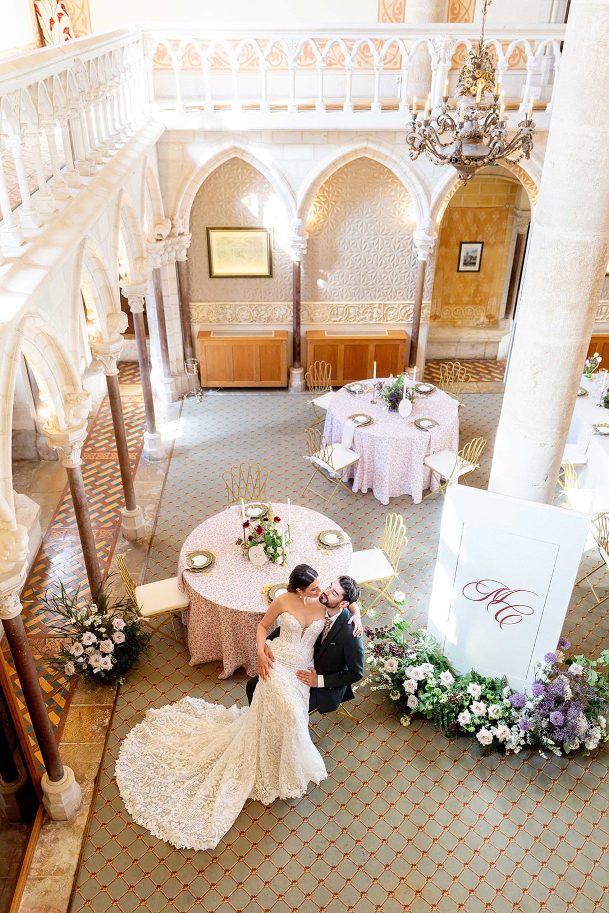 The couple at a round table in the reception hall, seen from above