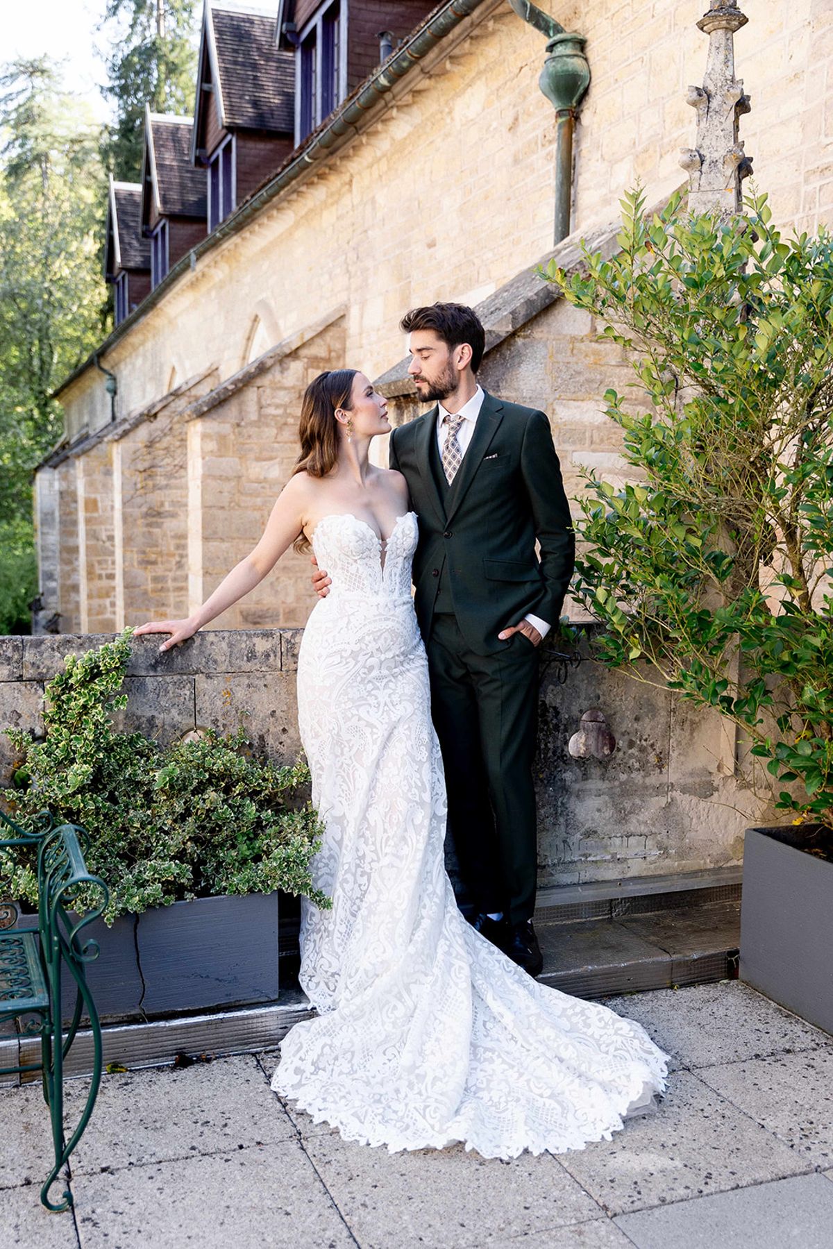The couple against the abbey's stone wall