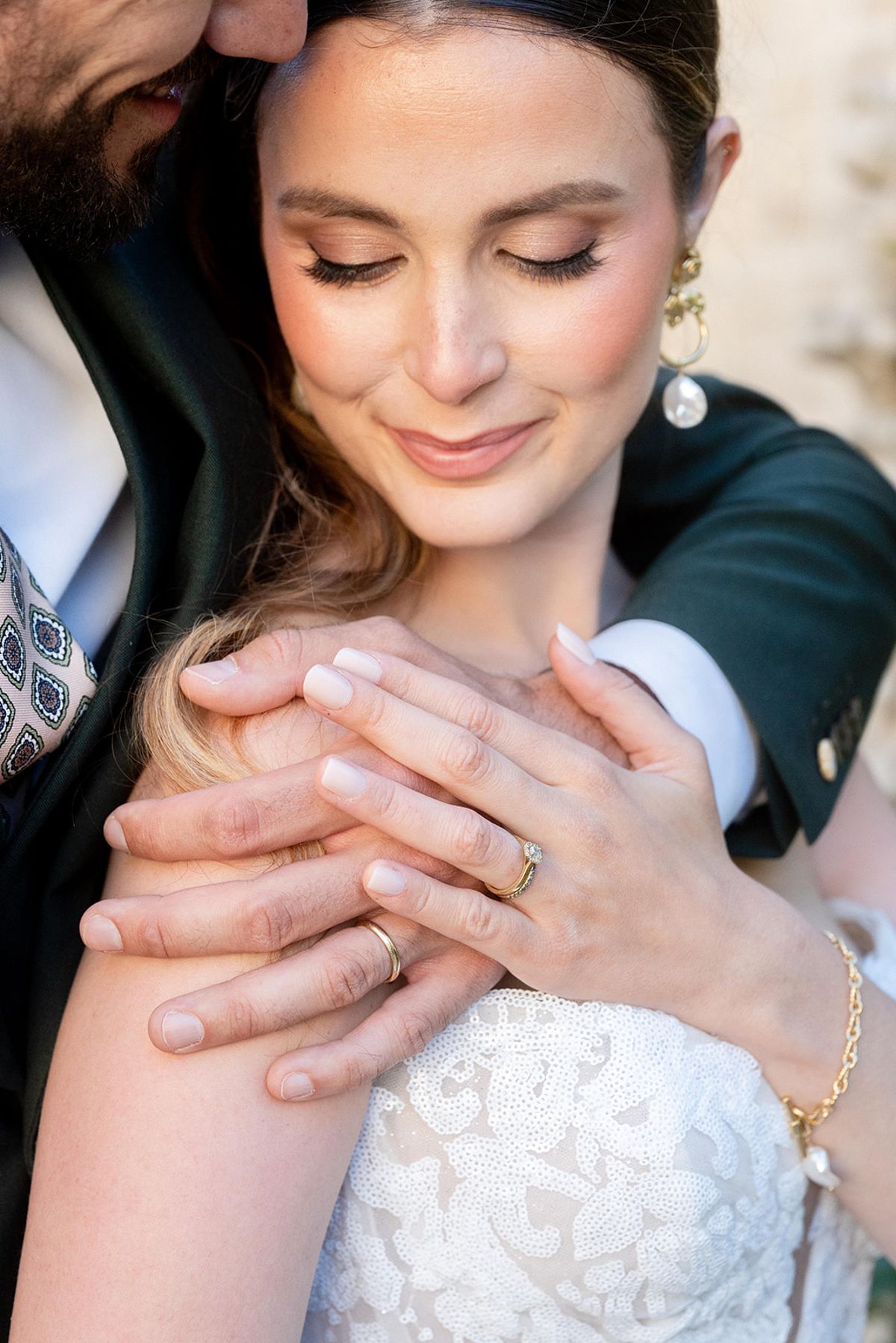 Close view of the couple embracing, their hands together
