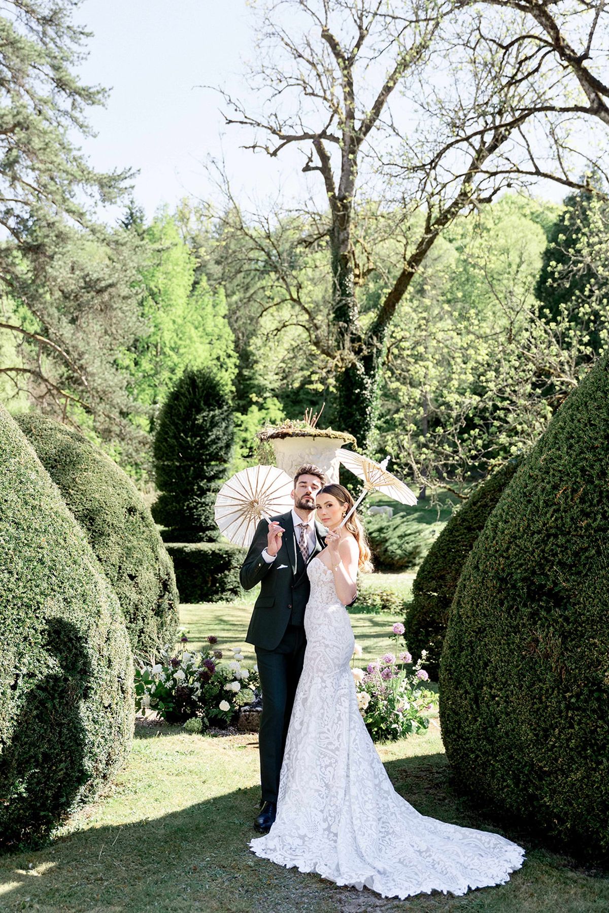 The couple under a paper parasol in the abbey gardens