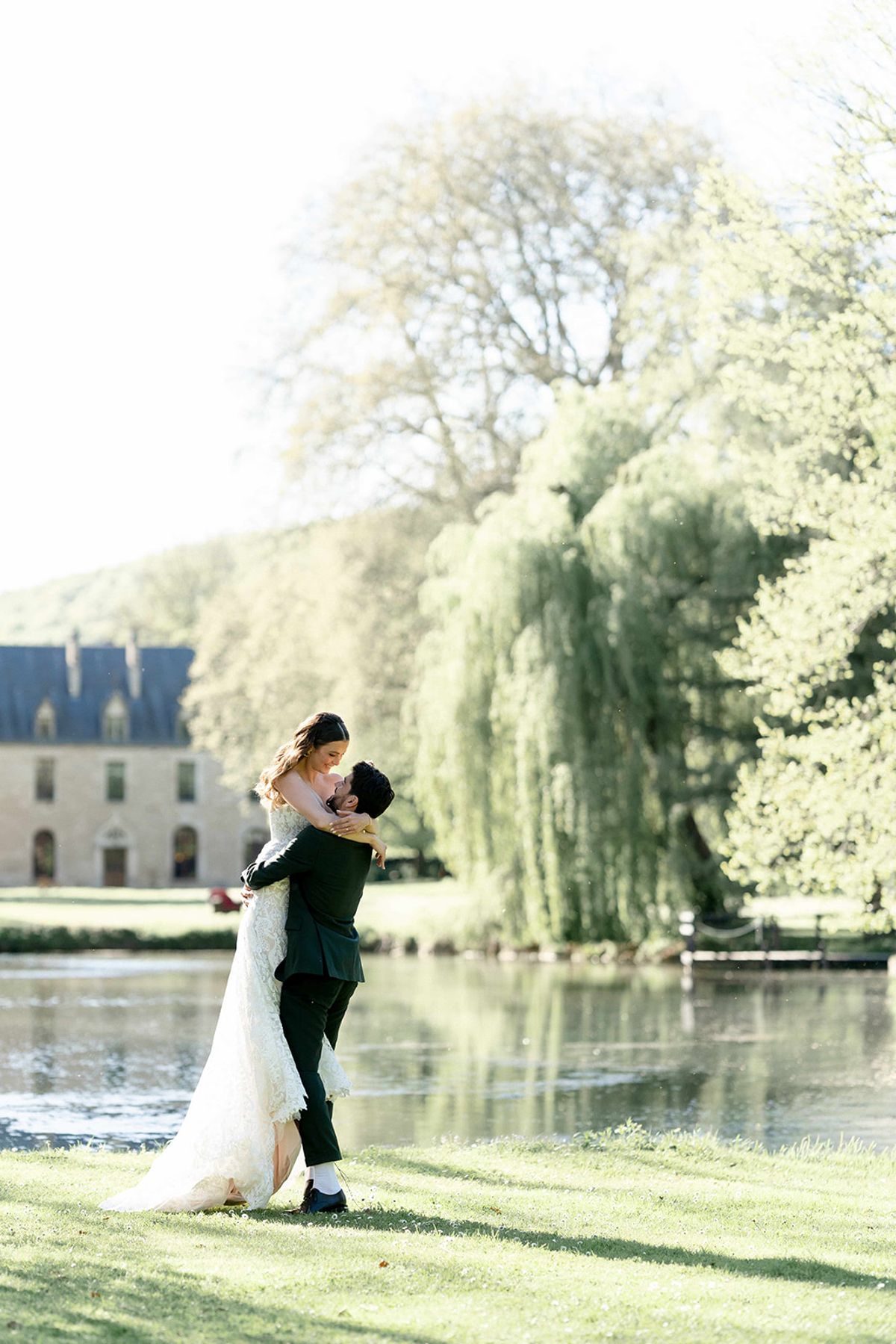 The couple by the lake with the abbey behind them