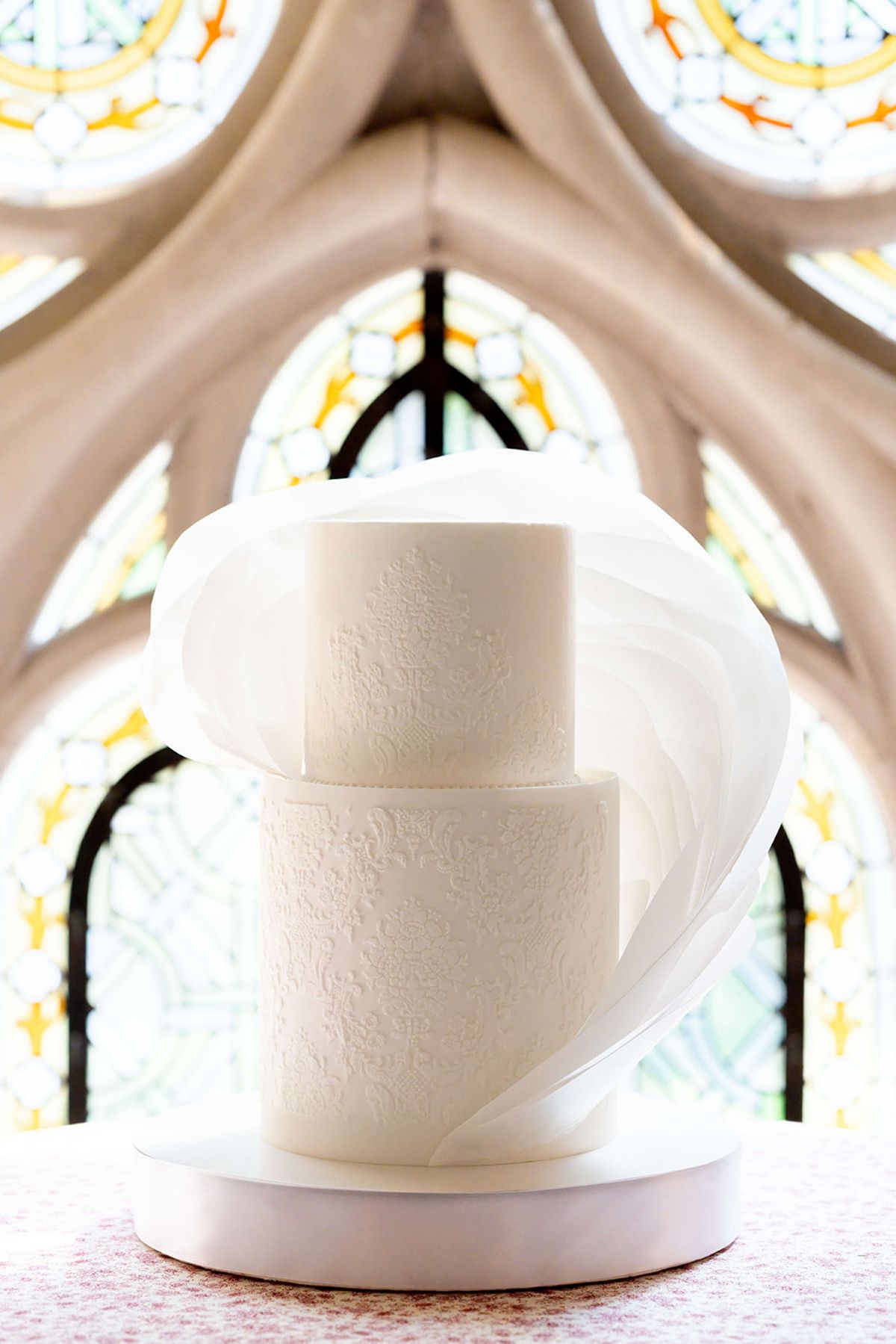 Close view of the wedding cake's draped and folded tiers