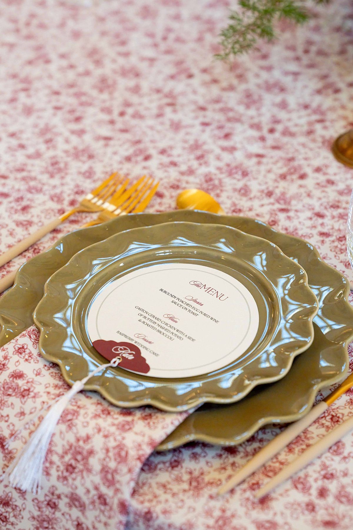 Overhead place setting with a menu card, charger plate and patterned cloth