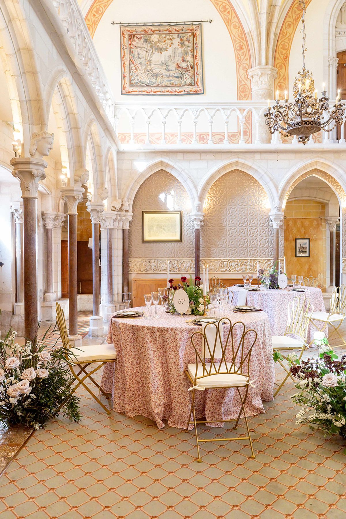 The reception hall set for dinner beneath the abbey's arcaded gallery
