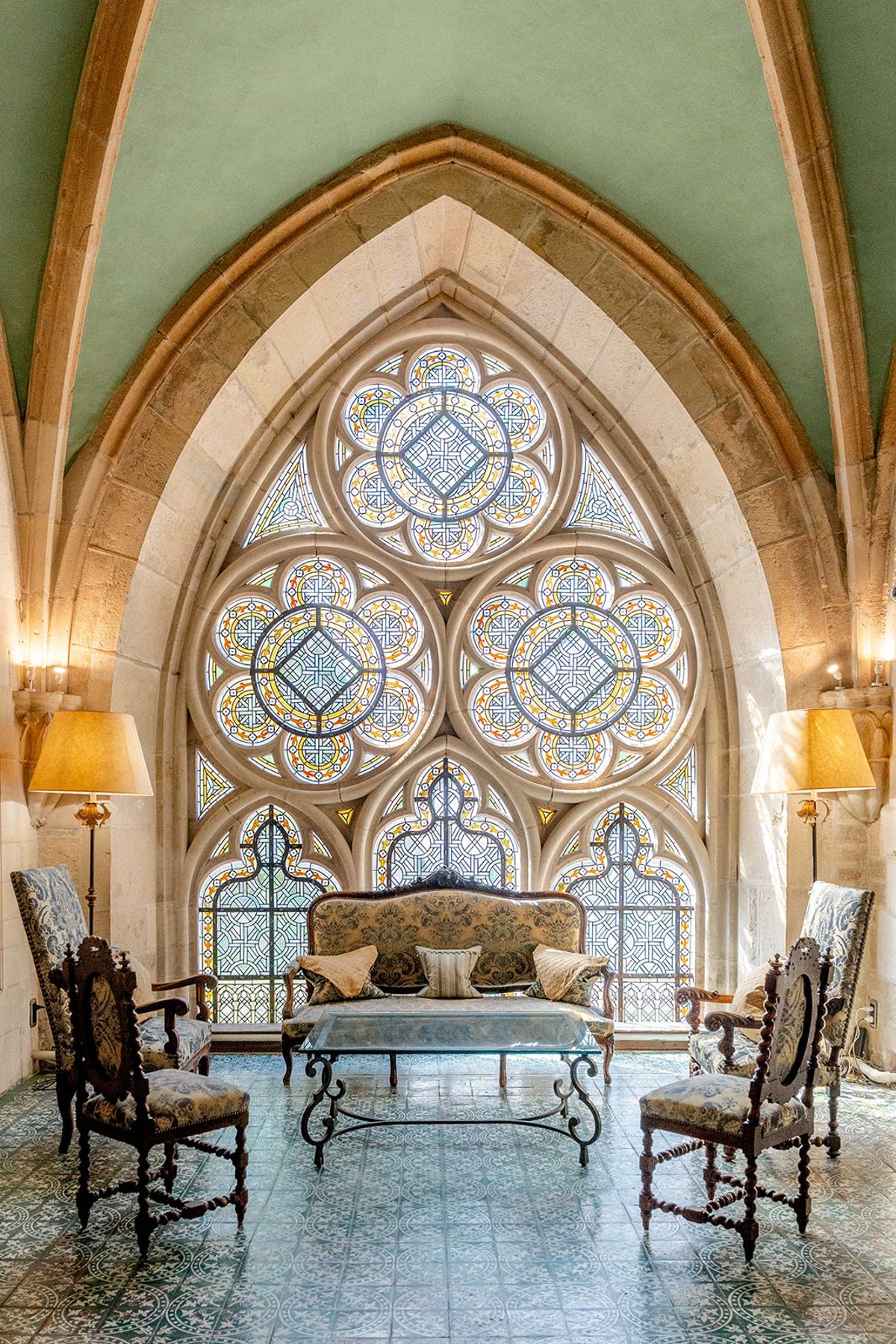 The abbey's vaulted chapel interior, with stained glass rose windows above the seating