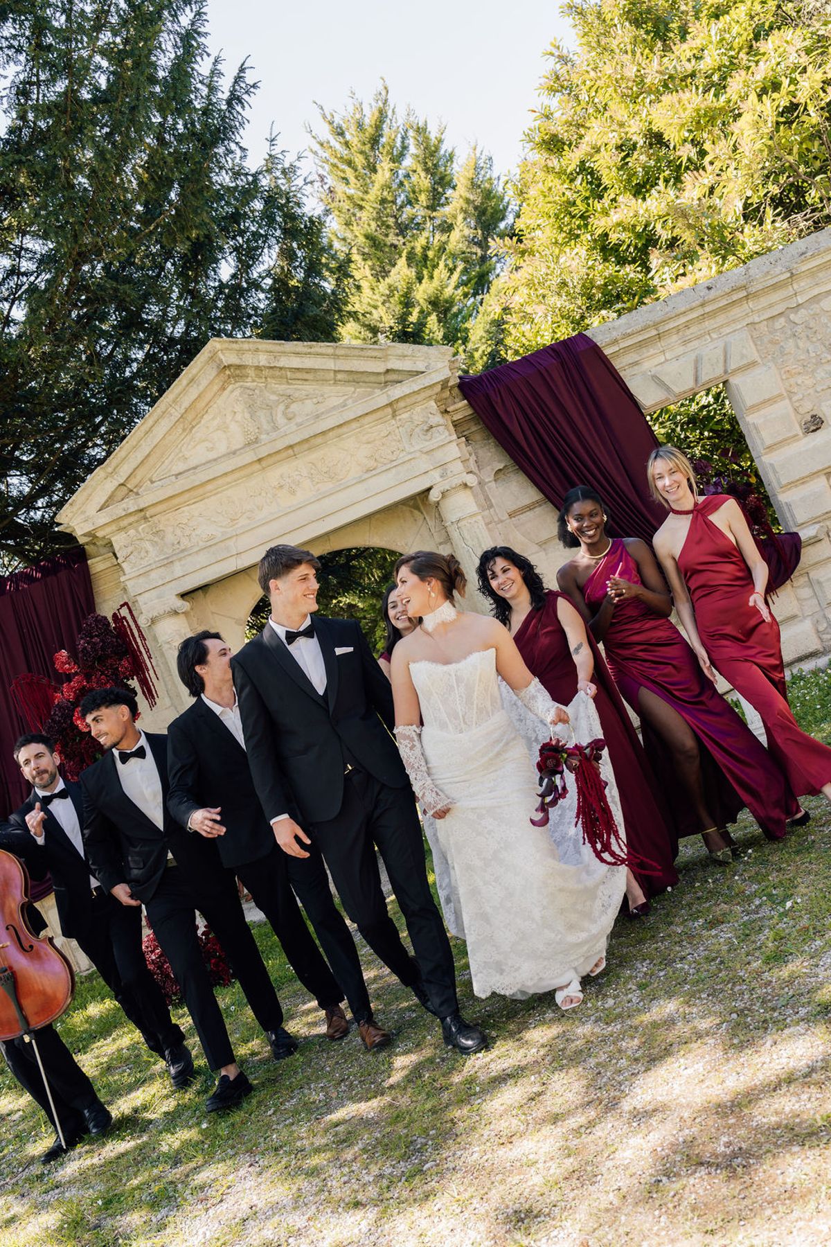 Styled shoot models Harper and Liam: the wedding party at the archway from a second angle, Chateau de Mirambeau, spring editorial