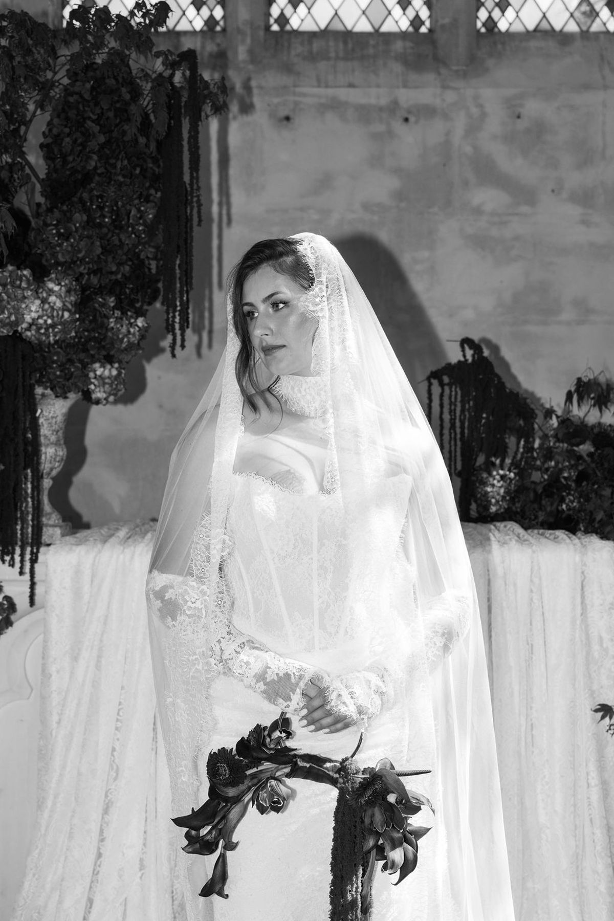 Styled shoot models Harper and Liam: a black-and-white portrait of the bride in her veil, Chateau de Mirambeau, spring editorial