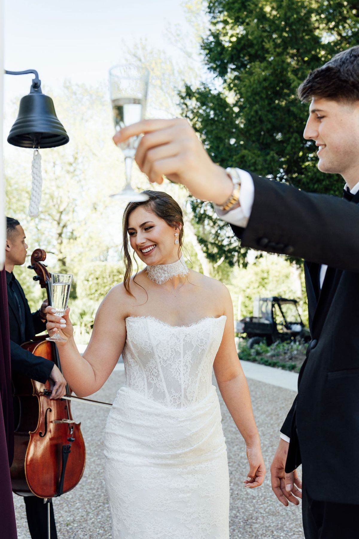 Styled shoot models Harper and Liam: the bride ringing the bell for a glass of champagne, Chateau de Mirambeau, spring editorial