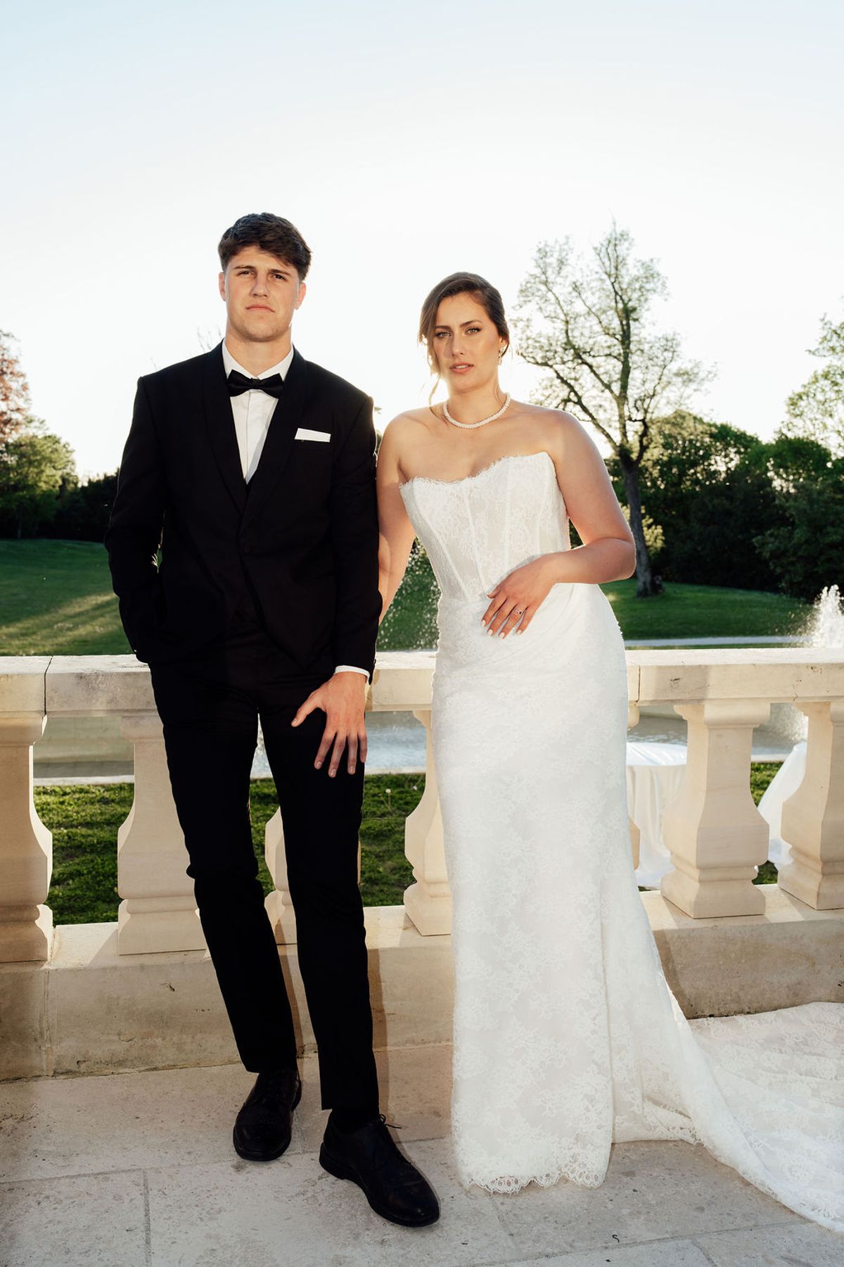 Styled shoot models Harper and Liam: the couple standing together on the terrace, Chateau de Mirambeau, spring editorial