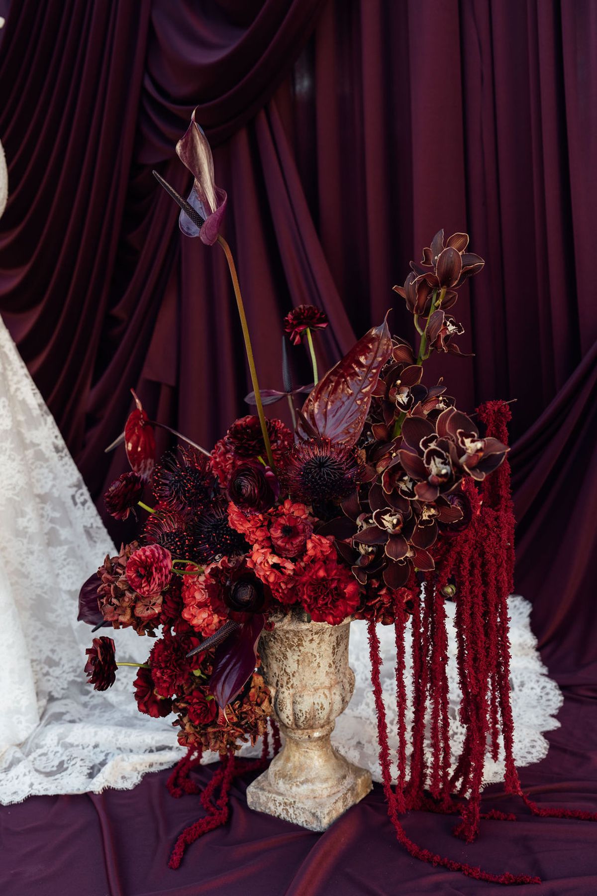Styled shoot models Harper and Liam: the floral installation framing the stone archway, Chateau de Mirambeau, spring editorial
