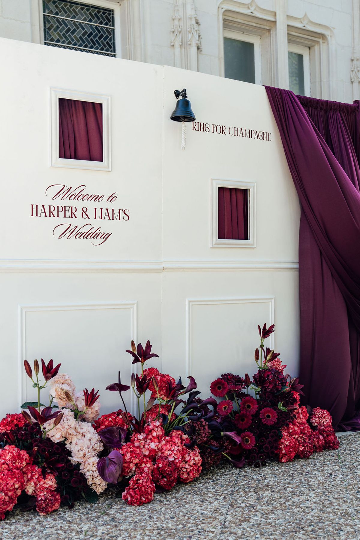 Styled shoot models Harper and Liam: a hand-painted welcome wall reading Harper and Liam's Wedding, Chateau de Mirambeau, spring editorial