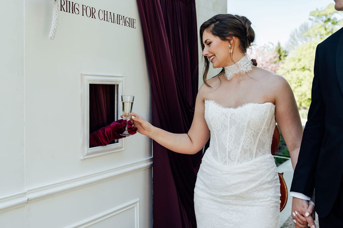 Styled shoot models Harper and Liam: the ring-for-champagne nook set into the chateau wall, Chateau de Mirambeau, spring editorial