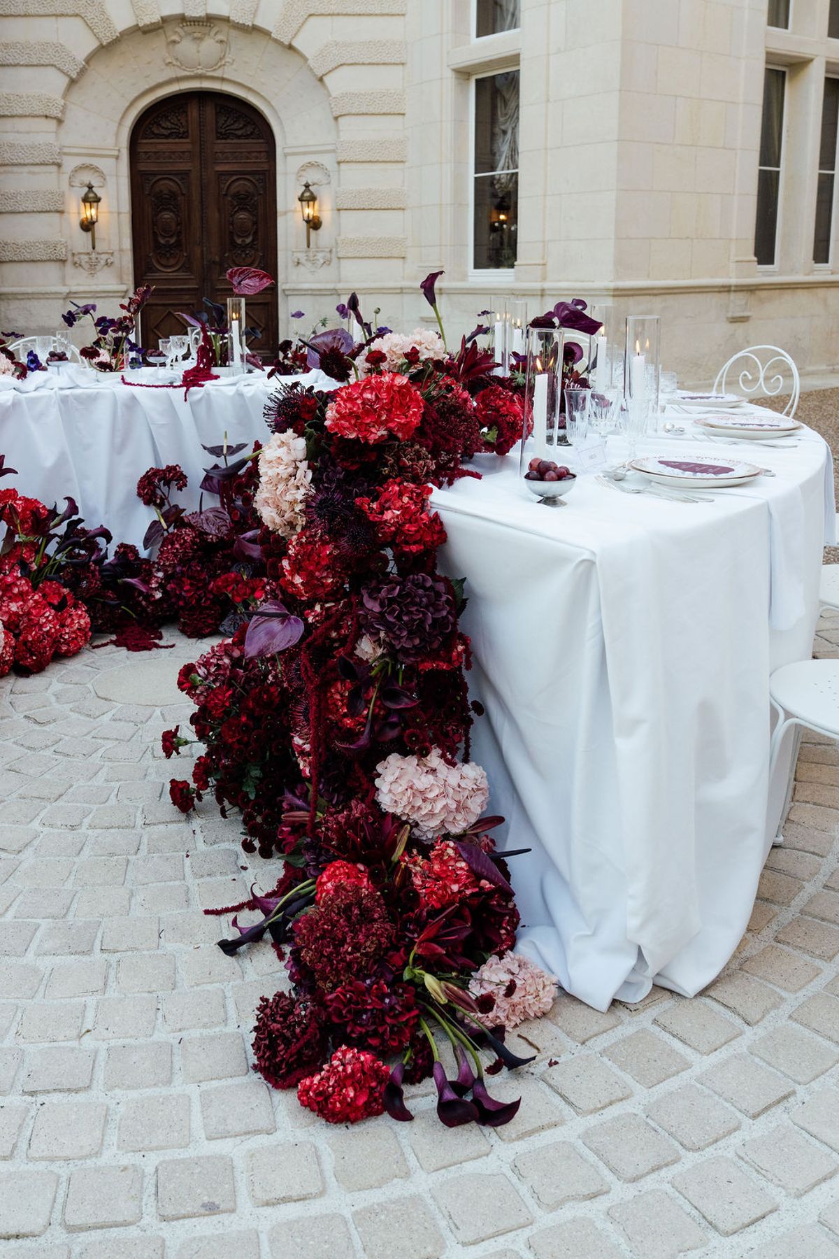 Styled shoot models Harper and Liam: the floral arch and table setting seen close, Chateau de Mirambeau, spring editorial