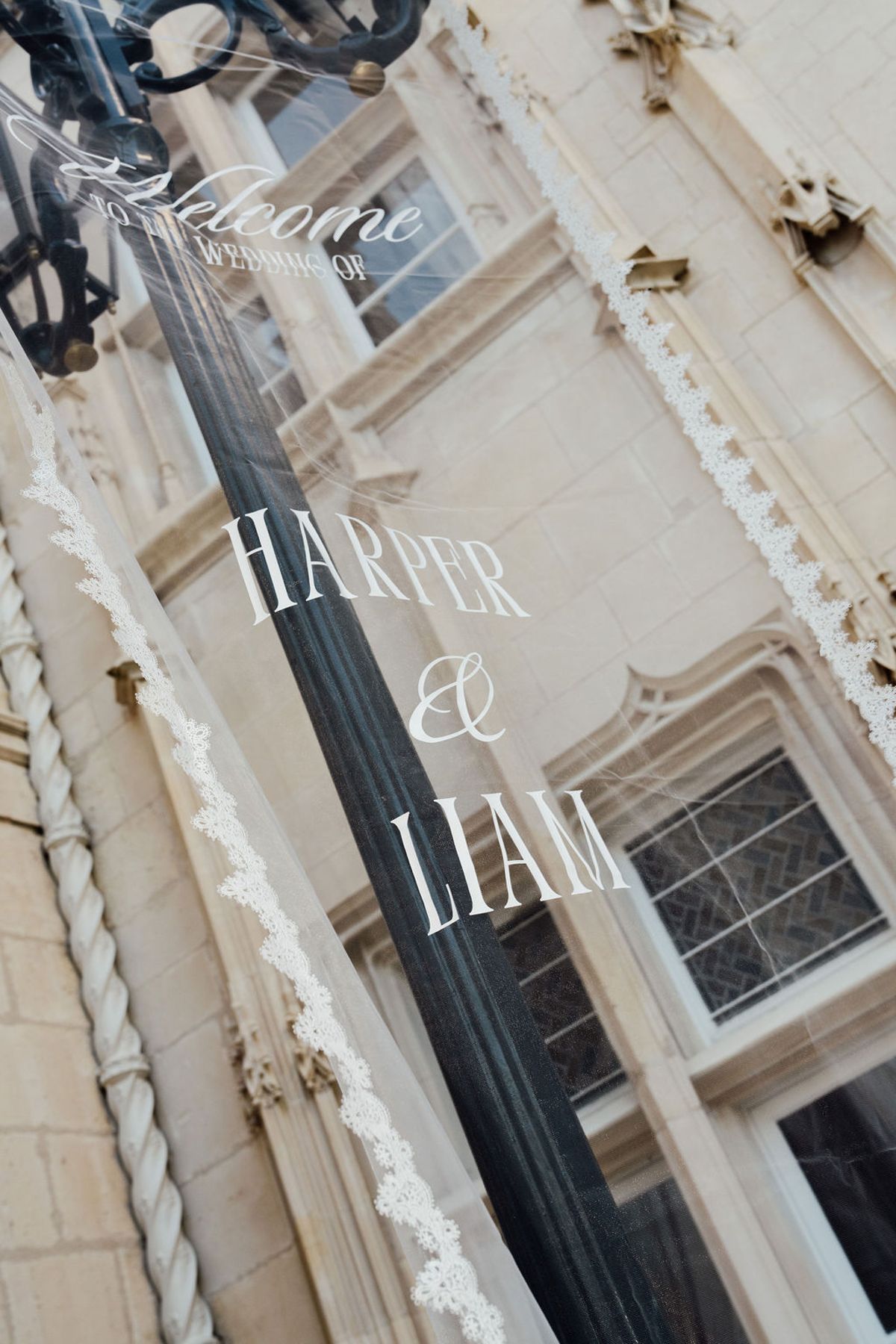 Styled shoot models Harper and Liam: Harper and Liam's names lettered on a chateau window, Chateau de Mirambeau, spring editorial