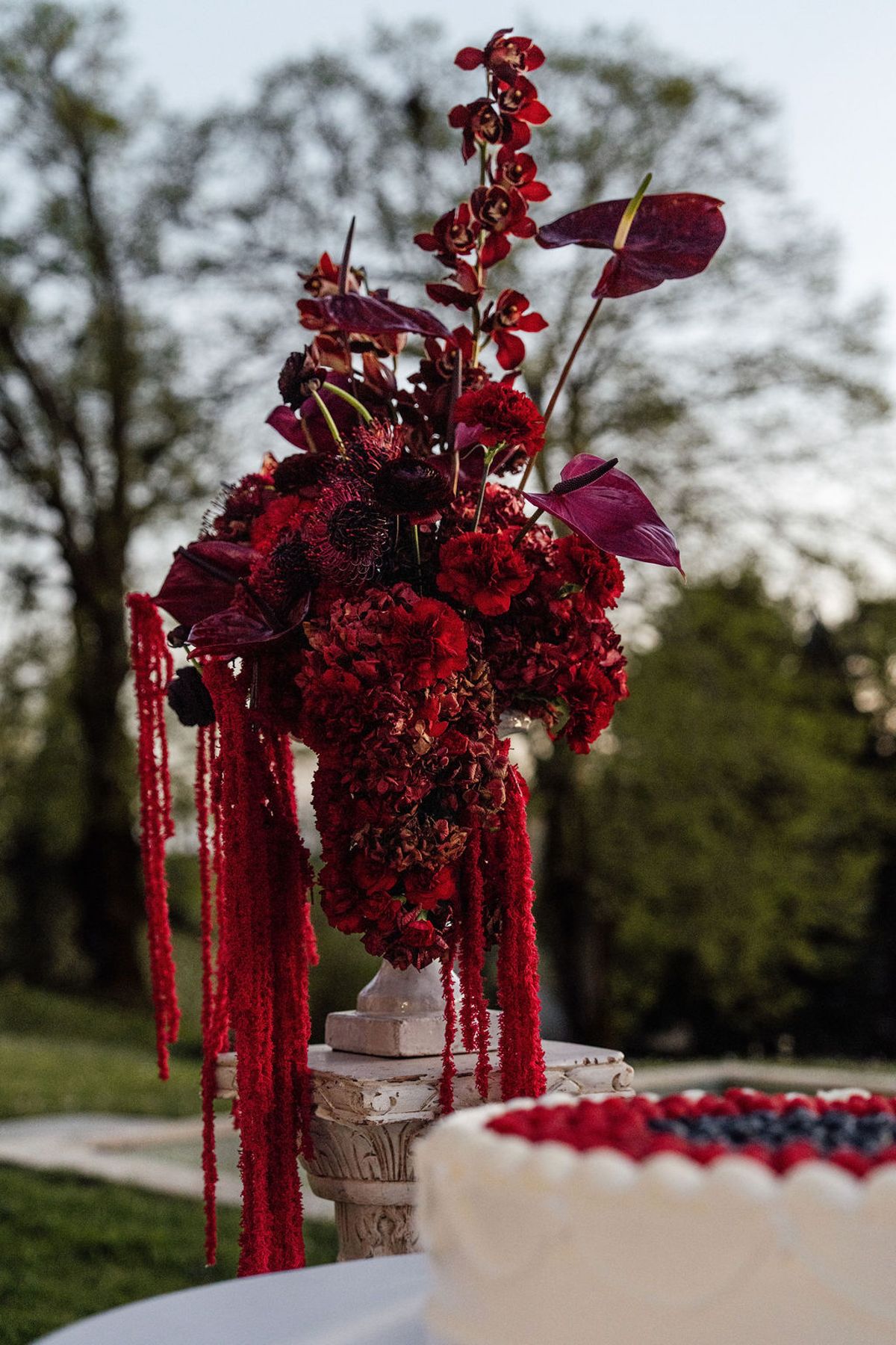 Styled shoot models Harper and Liam: a close study of the plum and burgundy floral installation, Chateau de Mirambeau, spring editorial
