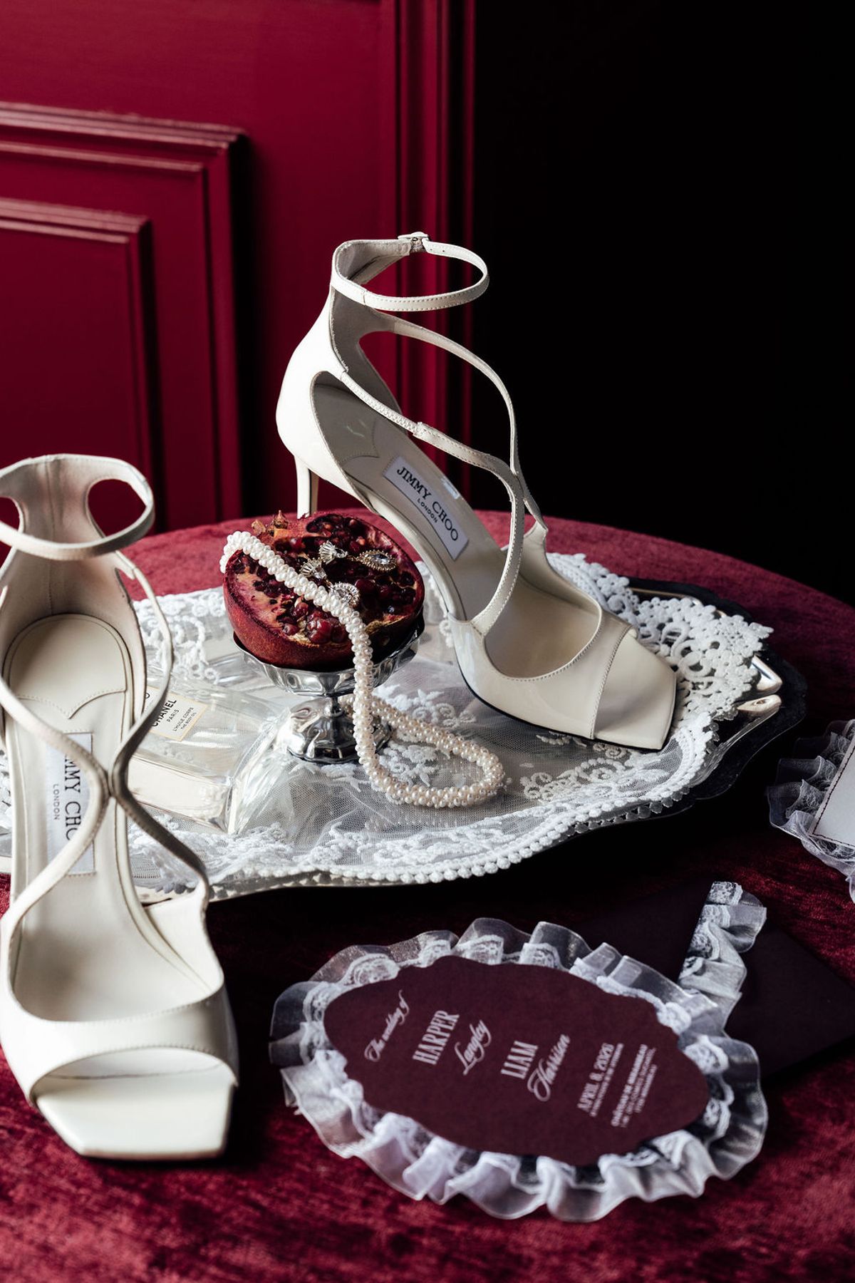 Styled shoot models Harper and Liam: ivory heels beside a pomegranate opened to show garnet-red seeds, Chateau de Mirambeau, spring editorial