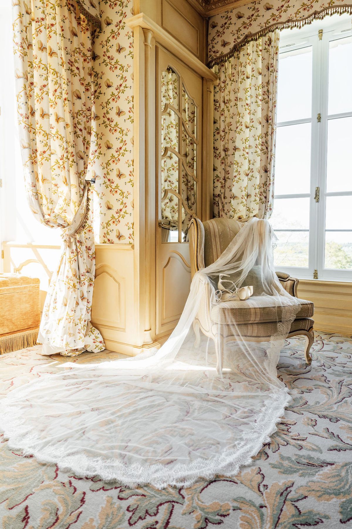 Styled shoot models Harper and Liam: the veil hanging in the window light, Chateau de Mirambeau, spring editorial