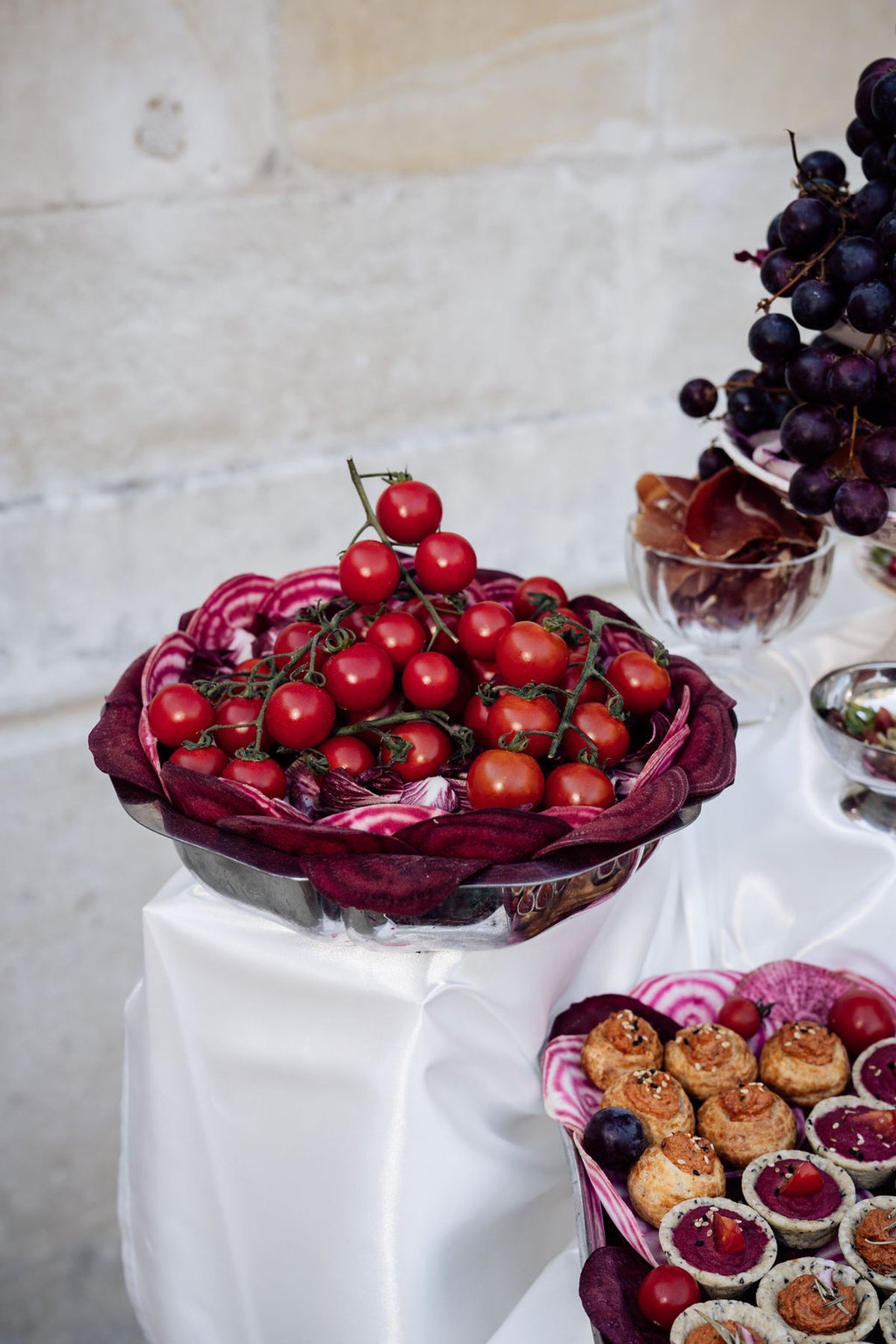 Styled shoot models Harper and Liam: a bowl of cherry tomatoes on the grazing table, Chateau de Mirambeau, spring editorial