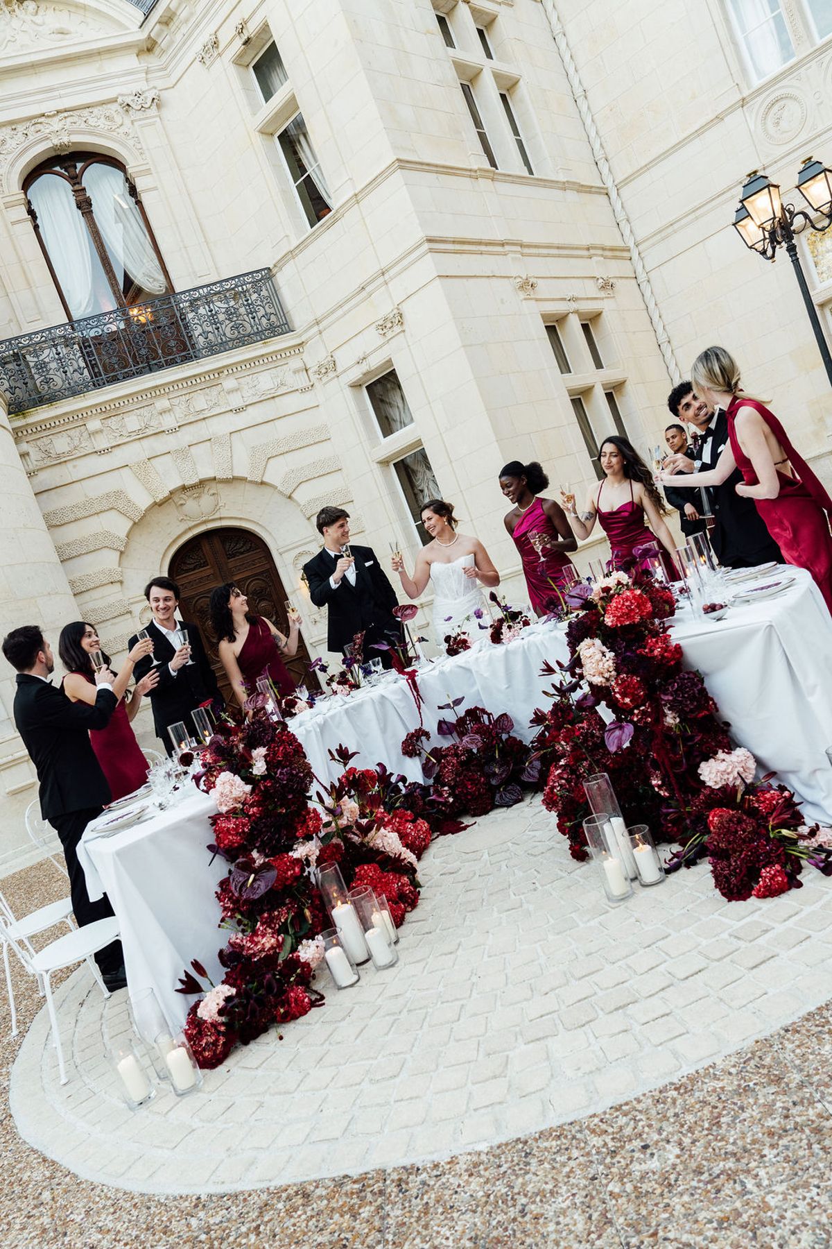 Styled shoot models Harper and Liam: the long table shown from a second angle with the wedding party, Chateau de Mirambeau, spring editorial